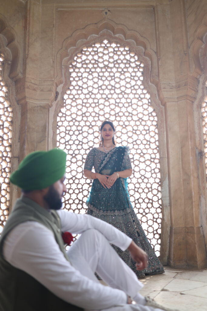 Bride posing gracefully in a royal heritage window during a romantic pre wedding shoot in Jaipur by Vishal Photos.