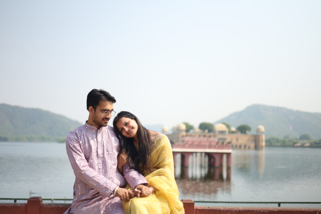 Couple posing naturally in traditional outfits during a candid pre-wedding photoshoot by Vishal Photos near Jal Mahal Jaipur
