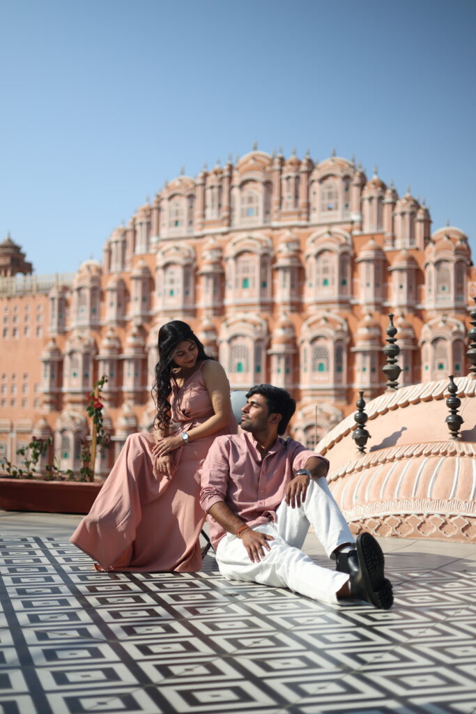 Romantic pre wedding couple sitting pose at Hawa Mahal Jaipur captured by Vishal Photos Jaipur with a cinematic royal backdrop.