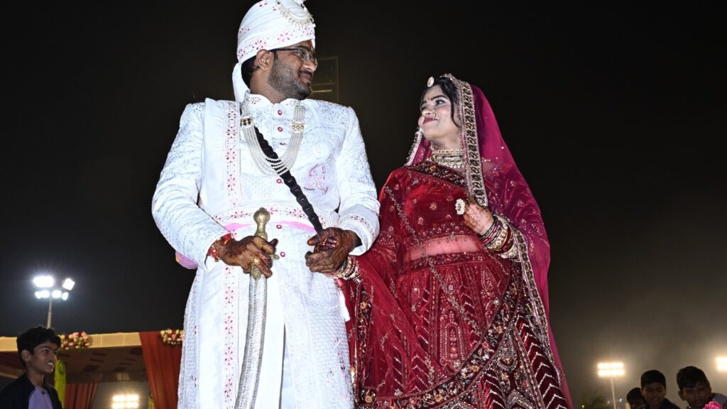 Destination wedding couple portrait in Jaipur featuring bride and groom in traditional royal wedding attire during a grand wedding ceremony.